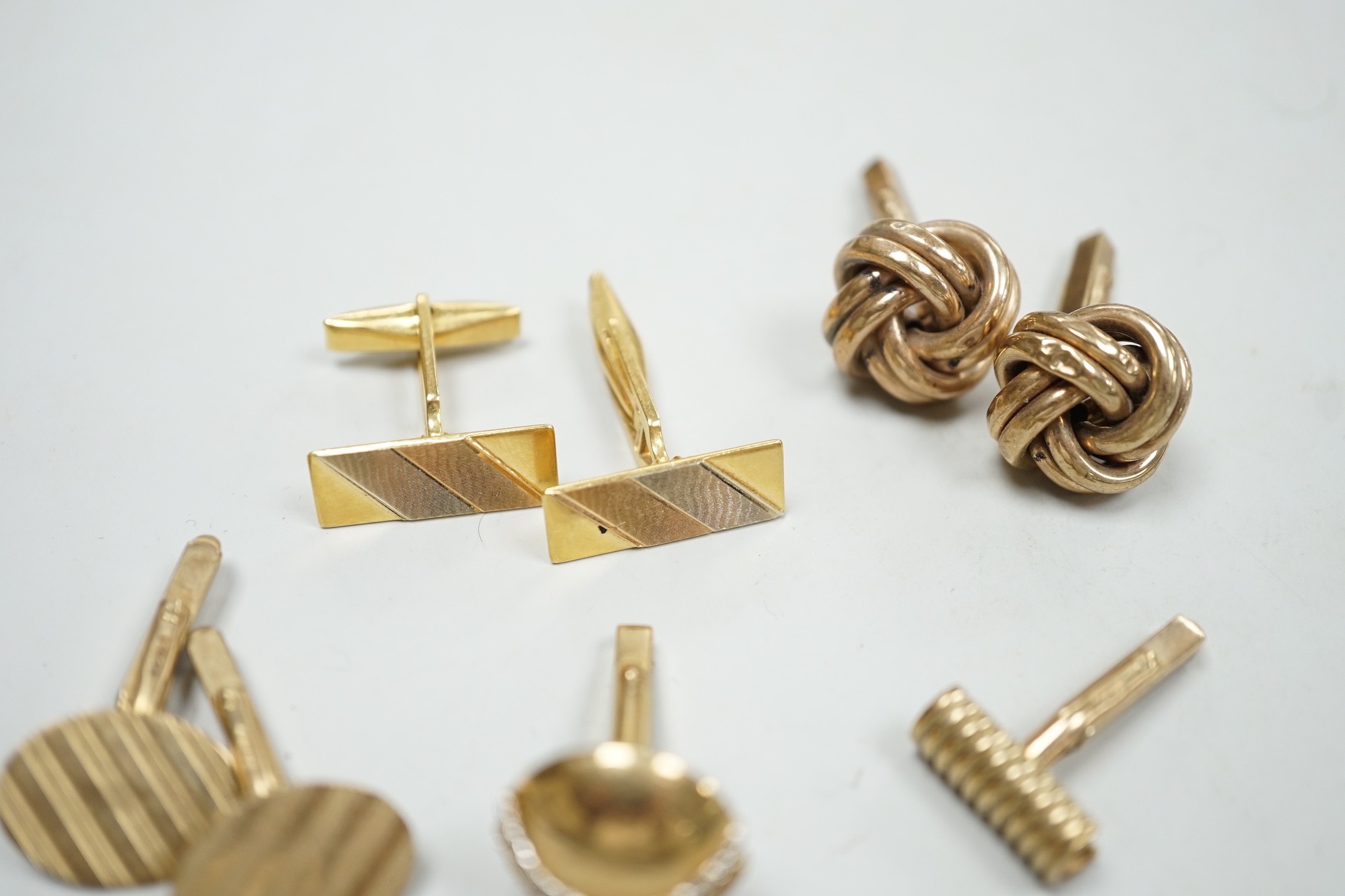 A modern three colour 750 pair of cufflinks, 9.2 grams, a pair of 9ct gold oval cufflinks one other 9ct gold pair and two odd 9ct gold cufflinks, 20.7 grams.